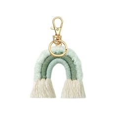 a green and white keychain with two tassels hanging from it's side