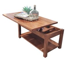 a wooden table with an open drawer underneath it and a pineapple on the top