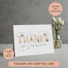 a thank card with flowers in a vase next to it