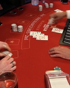 people playing cards at a casino table