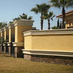 a row of yellow buildings with palm trees in the background