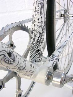 the front wheel of a bicycle with drawings on it