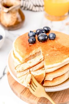 a stack of pancakes with blueberries on top