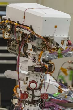 the robot is connected to wires and other electronic equipment