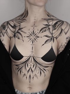 a woman with tattoos on her chest