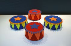 three circus themed cakes sitting on top of a table