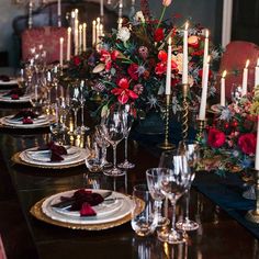 the table is set with candles, plates and napkins for an elegant dinner party