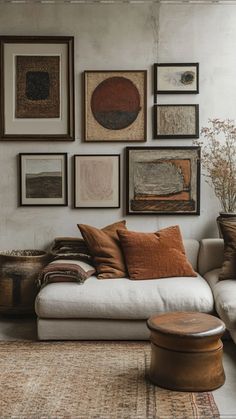 a living room filled with furniture and pictures on the wall above it's couch