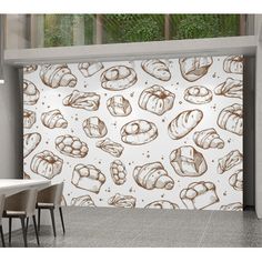 a large wall mural with breads on it in an office building, next to a table and chairs