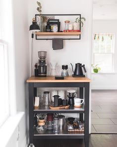 a coffee bar with shelves and cups on it