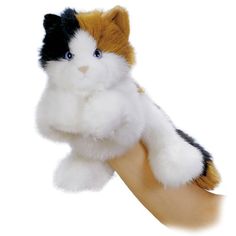 a hand holding a small stuffed cat on it's arm