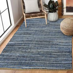 a living room area with a chair and rug