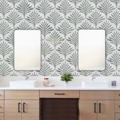 a bathroom with two sinks and mirrors on the wall