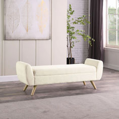 a white bench sitting on top of a carpeted floor next to a potted plant