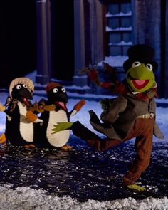 the muppets are playing in the snow with one another and two other penguins