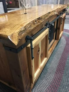 a large wooden counter top sitting on top of a carpeted floor next to a window