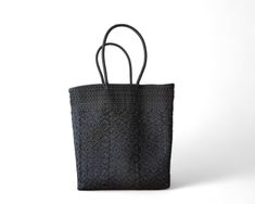 This Black Mexican artisan tote is a one-of-a-kind, handmade shoulder bag that combines elegance and traditional craftsmanship. Exclusive Artisan Craftsmanship: Handwoven by skilled artisans—only one piece available. Elegant Black Design: A classic black tote that pairs effortlessly with any outfit. Open-Top for Easy Access: Reach essentials quickly without closures or zippers. Comfortable Long Handles: Designed for convenient over-the-shoulder wear. Multi-Purpose Use: Perfect for shopping, office, beach outings, or daily adventures. Durable & Easy to Clean: Maintains shape, lightweight, and easy to keep looking fresh. Dimensions: 14 x 7 x 15 inchesColor: Black Handmade Black Bags With Double Handle, Handmade Black Double Handle Bag, Handmade Black Tote Bag, Black Handmade Rectangular Bag, Traditional Black Shoulder Bag As Gift, Traditional Black Shoulder Bag Gift, Traditional Black Shoulder Bag For Gift, Elegant Black Handwoven Shoulder Bag, Black Handwoven Shoulder Bag With Double Handle