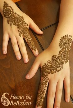 two hands with henna designs on them