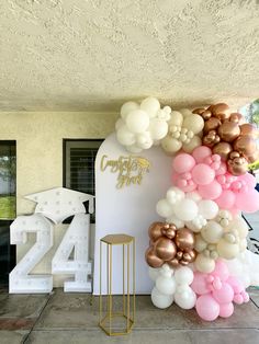 balloons are arranged in the shape of a number for a balloon arch at an event