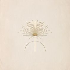 a drawing of a sunflower on a white paper with gold foilwork in the middle