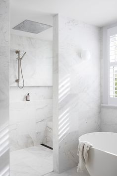 a white bath tub sitting next to a window