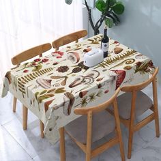 a table and chairs with a bottle of wine on top of it next to a potted plant