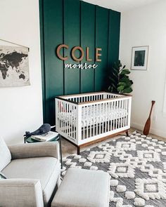 a baby's room with a white crib and green wall behind the crib