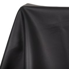 the back of a black leather chair with an open seat cover on top of it