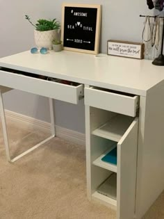 a white desk with two drawers and a chalkboard