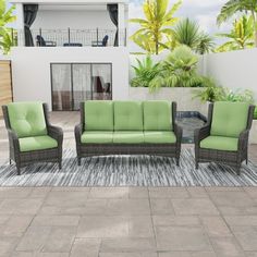 an outdoor patio furniture set with green cushions