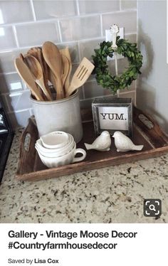 a tray with utensils and spoons in it on a kitchen counter top