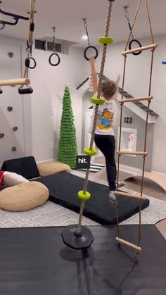 a child is climbing on a ladder in a play room