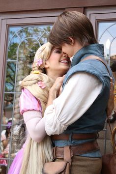 a man and woman dressed up as rappui and princesses hugging each other