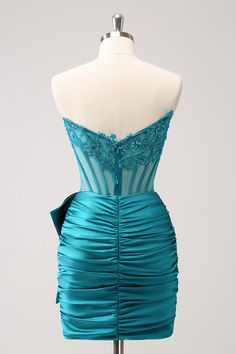 a dress on a mannequin with blue fabric and lace at the bust, in front of a white background