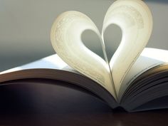 an open book with two pages shaped like a heart