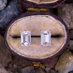 This lovely pair of emerald cut diamond stud earrings each feature one (1) emerald cut diamond set into a four-prong setting. The earrings are finished with friction backs and posts for pierced ears. Classic Emerald Cut Baguette Diamond Jewelry, Fine Jewelry Earrings With Baguette Diamonds In Emerald Cut, Emerald Cut Baguette Diamond Anniversary Earrings, Emerald Cut Baguette Diamond Earrings For Anniversary, Emerald Cut Baguette Diamond Earrings, Wedding Earrings With Baguette Diamonds In Emerald Cut, Wedding Earrings With Emerald Cut Baguette Diamonds, Baguette Diamond Earrings With Emerald Cut For Wedding, Classic Diamond Earrings With Baguette Diamonds