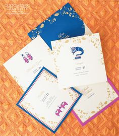 four different types of wedding cards on an orange surface with gold and blue trimmings