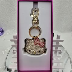 a hello kitty keychain in a pink box