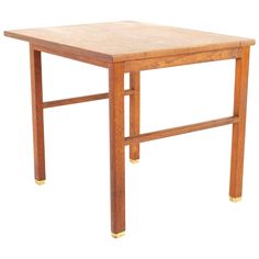 a wooden table with gold legs on a white background