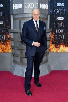 an older man in a suit and tie at the game of thrones red carpet