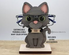 a cat figurine with glasses on it's head