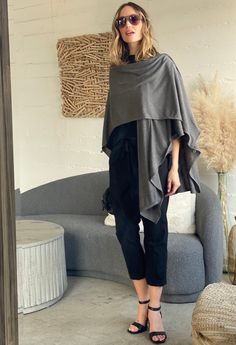 This is one from the archives! Part cardigan, part wrap, this incredibly versatile piece even converts into a scarf! With overwhelming demand, we had to bring this gem back. "The Kimono Cardi in black has been on EVERY SINGLE trip I've taken in the past 7 years," says our founder, Mary. Perfect for chilly plane rides or cool evenings, the clever buttons allow you to wear the cardigan multiple ways. Over leggings post-yoga, you're ready for errands. As a wrap over a caftan, you're ready for coole Black Shawl Wrap For Fall, Black Shawl For Fall, Black Scarf For Fall, Elegant One-size Poncho For Layering, Elegant One Size Poncho For Layering, Elegant Shawl Wrap For Layering, Elegant Shawl Wraps For Layering, Versatile Shawl For Fall Layering, Grey Kimono