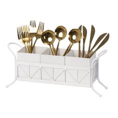 a white caddy filled with gold colored utensils and spoons on a white background