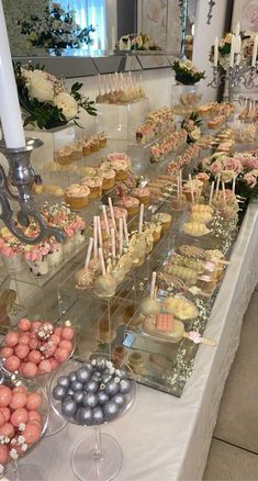 a table filled with cupcakes and other treats