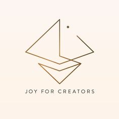 the joy for creators logo is shown in gold on a white background with an orange dot