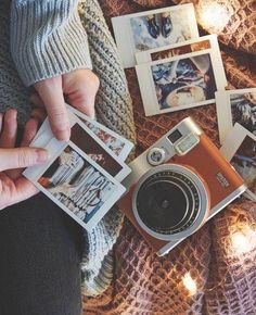 a person holding an old camera and taking pictures with their instagrams on the table