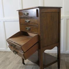 an old wooden desk with two drawers on it