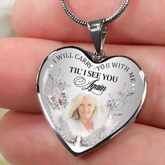 a person holding a heart shaped necklace with the words i will carry you with me