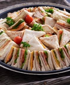 a platter full of sandwiches on a table