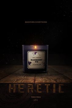 a candle that is sitting on top of a wooden table with the words heretic